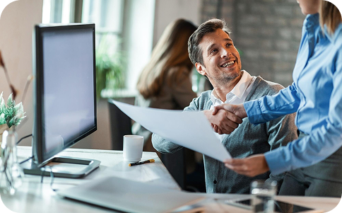 IT consultant shaking hands with client